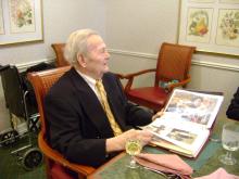 Dad enjoys the book we made for his 90th